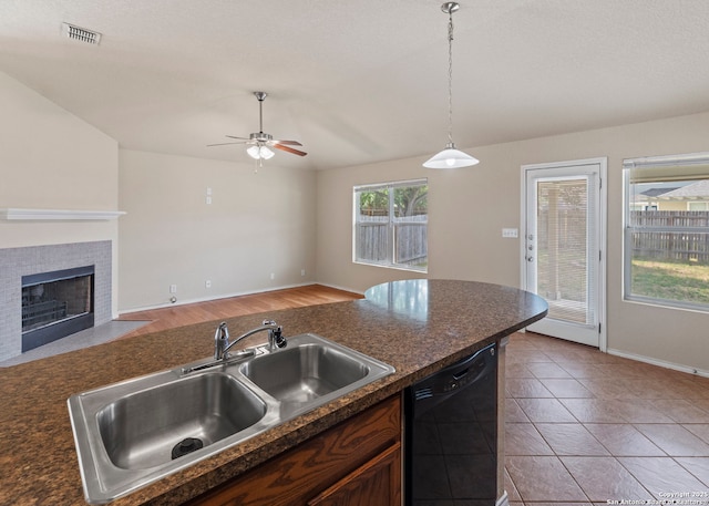 7319 Tranquillo Way, San Antonio, TX 78266 - kitchen with black dishwasher, a sink, dark countertops, a ceiling fan, and open floor plan