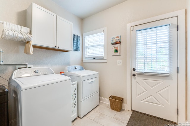 2045 W Mistletoe Ave, San Antonio, TX 78201 - laundry area featuring cabinet space, washer and dryer, light tile patterned floors, and baseboards