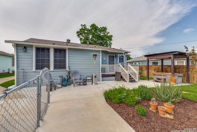 2045 W Mistletoe Ave, San Antonio, TX 78201 - rear view of house featuring a covered hot tub, a fenced backyard, and a patio area