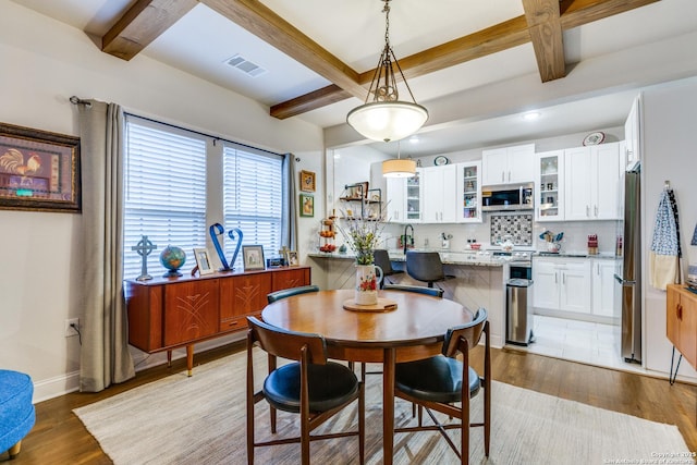2045 W Mistletoe Ave, San Antonio, TX 78201 - dining space with beam ceiling, coffered ceiling, light wood finished floors, and baseboards