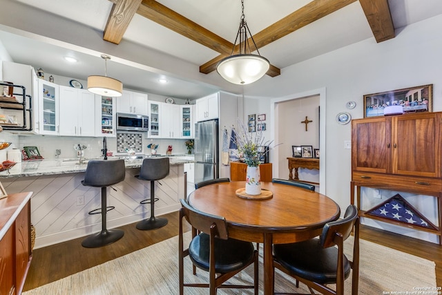 2045 W Mistletoe Ave, San Antonio, TX 78201 - dining area featuring dark wood finished floors, beam ceiling, and recessed lighting