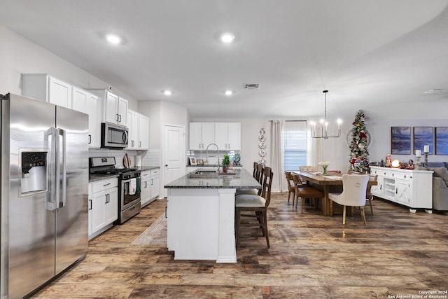 29416 Autumn Copper, Bulverde, TX 78163 - kitchen with stainless steel appliances, a sink, dark wood-style floors, a chandelier, and white cabinets