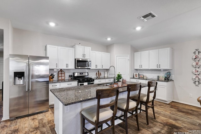 29416 Autumn Copper, Bulverde, TX 78163 - kitchen with appliances with stainless steel finishes, a sink, tasteful backsplash, a kitchen breakfast bar, and white cabinets