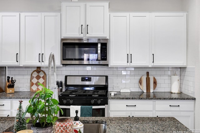 29416 Autumn Copper, Bulverde, TX 78163 - kitchen with stainless steel appliances, white cabinetry, decorative backsplash, and dark stone counters