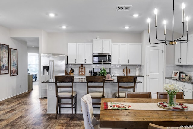 29416 Autumn Copper, Bulverde, TX 78163 - kitchen featuring stainless steel appliances, tasteful backsplash, dark wood-type flooring, a chandelier, and white cabinets