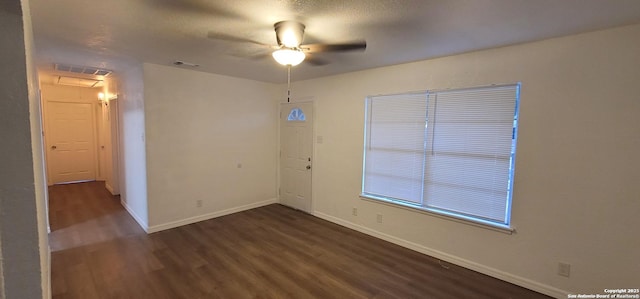 359 Revlon, San Antonio, TX 78227 - spare room featuring dark wood finished floors, a ceiling fan, and baseboards