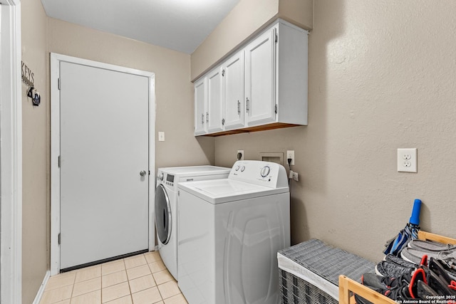 2002 Encino Vly, San Antonio, TX 78259 - laundry room with cabinet space, washer and clothes dryer, and light tile patterned flooring