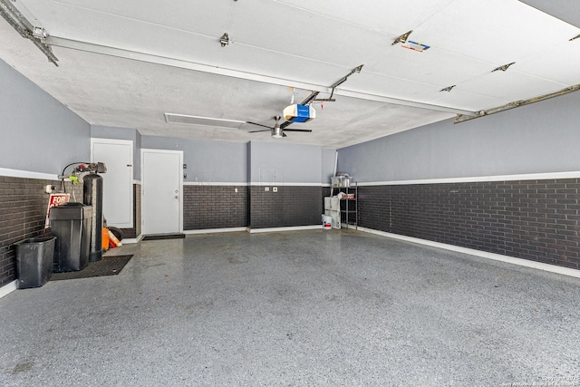 2002 Encino Vly, San Antonio, TX 78259 - garage featuring a garage door opener, baseboards, and wainscoting