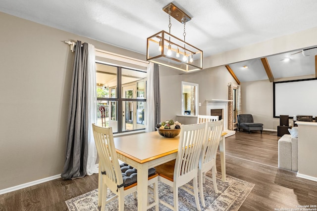 2002 Encino Vly, San Antonio, TX 78259 - dining space featuring a chandelier, baseboards, dark wood-style flooring, and a fireplace