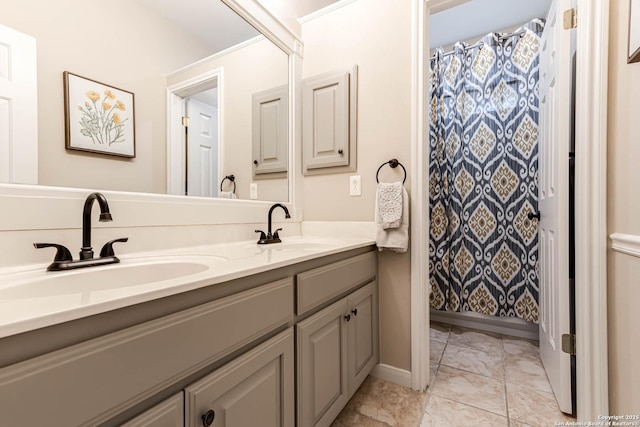 6502 Amber Oak, San Antonio, TX 78249 - bathroom featuring double vanity, marble finish floors, baseboards, and a shower with curtain