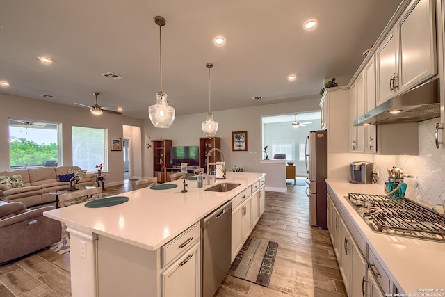 14815 Highdere, San Antonio, TX 78245 - kitchen featuring stainless steel appliances, ceiling fan, open floor plan, a sink, and under cabinet range hood
