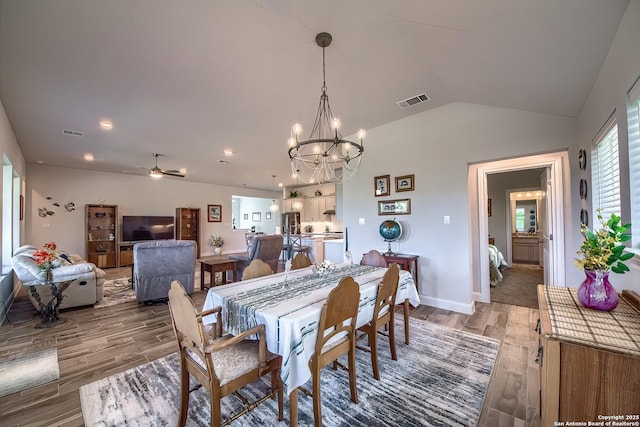 14815 Highdere, San Antonio, TX 78245 - dining space featuring light wood-style flooring, a chandelier, vaulted ceiling, a ceiling fan, and baseboards