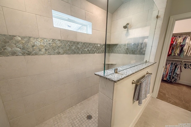14815 Highdere, San Antonio, TX 78245 - full bathroom featuring a walk in shower, a spacious closet, and tile patterned flooring
