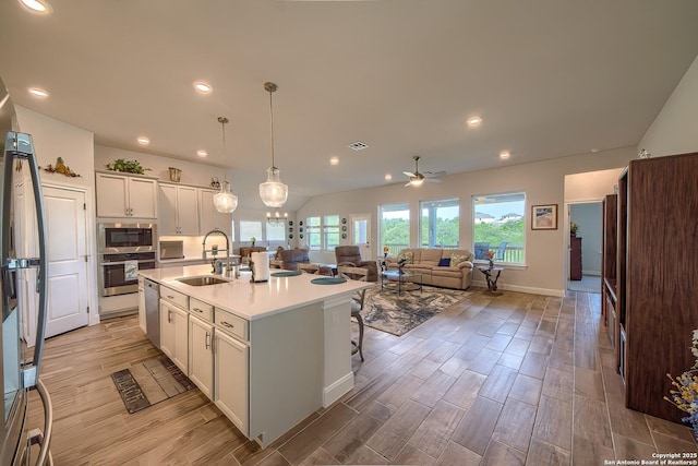 14815 Highdere, San Antonio, TX 78245 - kitchen featuring a sink, stainless steel appliances, light wood finished floors, a ceiling fan, and a center island with sink