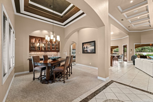 208 Cascade Caverns, Boerne, TX 78015 - dining space with ornamental molding, a high ceiling, a chandelier, baseboards, and arched walkways