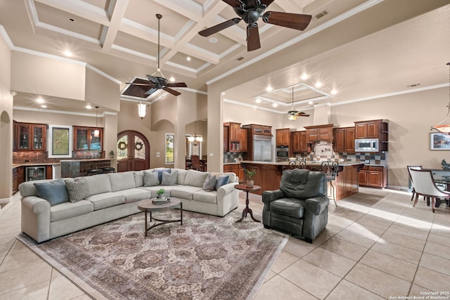 208 Cascade Caverns, Boerne, TX 78015 - living room with ceiling fan, a towering ceiling, light tile patterned floors, arched walkways, and crown molding