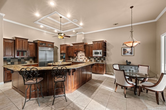 208 Cascade Caverns, Boerne, TX 78015 - kitchen with built in appliances, crown molding, a large island with sink, tasteful backsplash, and ceiling fan