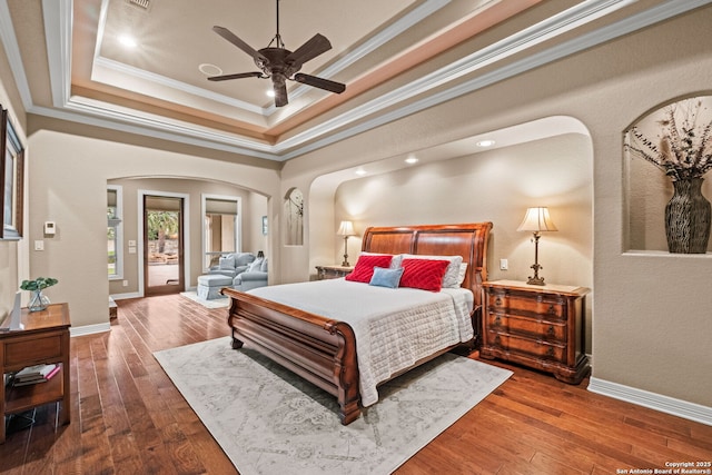 208 Cascade Caverns, Boerne, TX 78015 - bedroom with arched walkways, ornamental molding, hardwood / wood-style flooring, a raised ceiling, and access to exterior