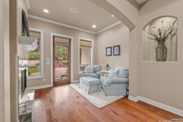 208 Cascade Caverns, Boerne, TX 78015 - sitting room featuring wood-type flooring, crown molding, arched walkways, baseboards, and recessed lighting