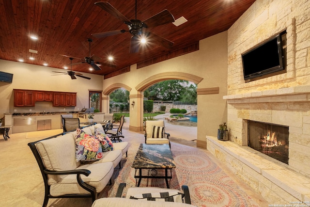 208 Cascade Caverns, Boerne, TX 78015 - view of patio with exterior kitchen, an outdoor living space with a fireplace, a ceiling fan, and a sink