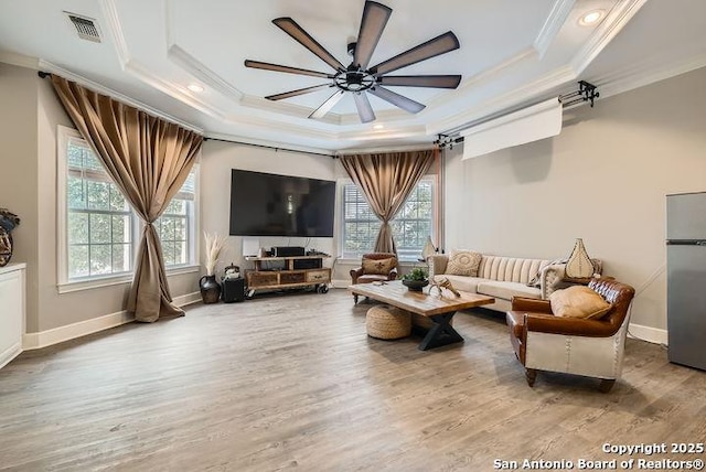 41 Champions Run, San Antonio, TX 78258 - living room featuring a tray ceiling, ornamental molding, ceiling fan, wood finished floors, and baseboards