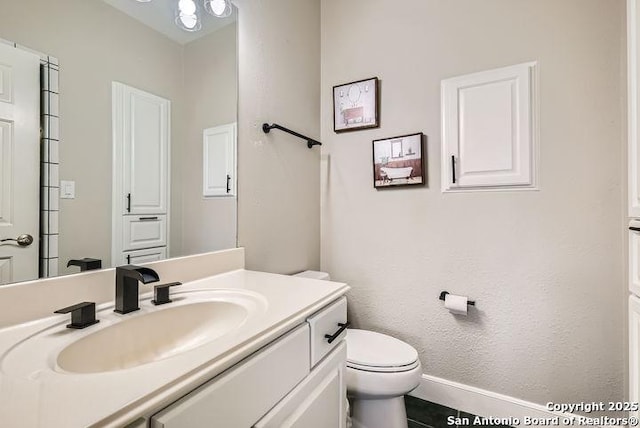 41 Champions Run, San Antonio, TX 78258 - bathroom with toilet, vanity, and baseboards