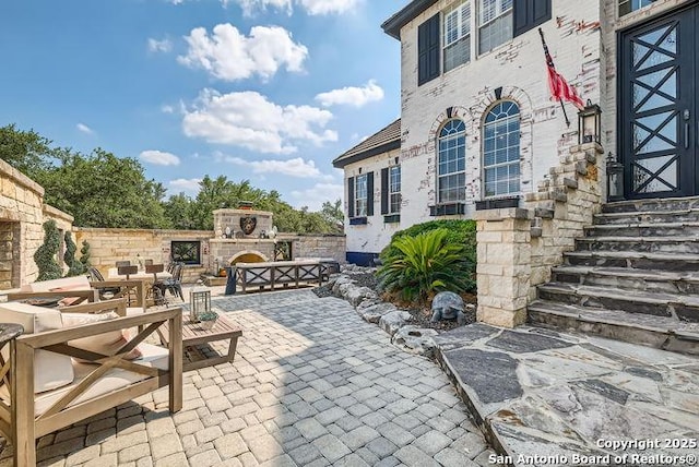 41 Champions Run, San Antonio, TX 78258 - view of patio featuring an outdoor stone fireplace and entry steps