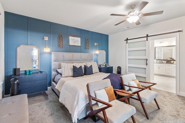 12815 Fort Belknap, San Antonio, TX 78245 - bedroom featuring a barn door, carpet flooring, connected bathroom, and ceiling fan