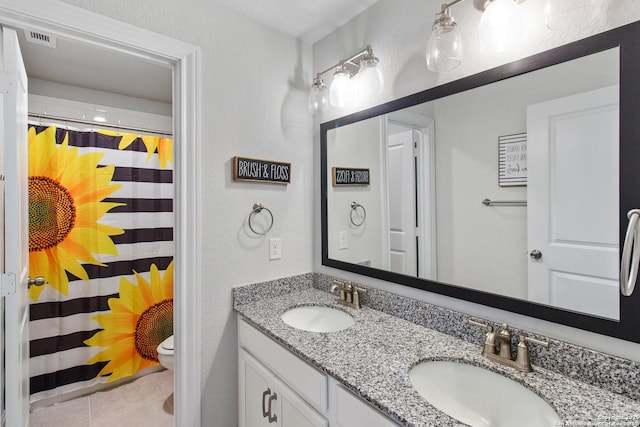 12815 Fort Belknap, San Antonio, TX 78245 - full bath with double vanity, toilet, tile patterned floors, and curtained shower