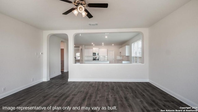 21055 Millstream Bnd, San Antonio, TX 78266 - unfurnished living room featuring arched walkways, ceiling fan, dark wood-type flooring, baseboards, and recessed lighting
