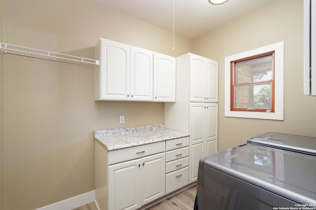 25927 Echo Mtn, San Antonio, TX 78260 - washroom featuring cabinet space, separate washer and dryer, and light wood-style floors