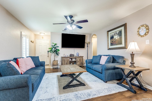 11334 Luckey Ledge, San Antonio, TX 78252 - living room with wood finished floors, arched walkways, a ceiling fan, and baseboards
