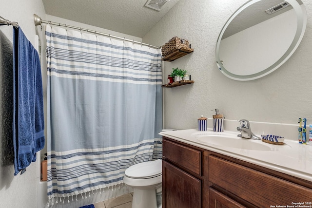 11334 Luckey Ledge, San Antonio, TX 78252 - bathroom featuring vanity, toilet, a textured ceiling, a textured wall, and tile patterned floors