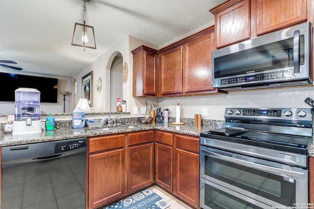 11334 Luckey Ledge, San Antonio, TX 78252 - kitchen featuring appliances with stainless steel finishes, a sink, stone counters, and light tile patterned flooring