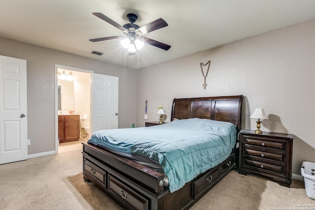 11334 Luckey Ledge, San Antonio, TX 78252 - bedroom with light carpet, baseboards, ensuite bath, and a ceiling fan