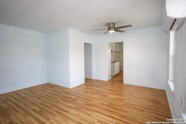 811 N Archer, Beeville, TX 78102 - unfurnished bedroom featuring a wall mounted air conditioner, light wood-style flooring, baseboards, and a ceiling fan