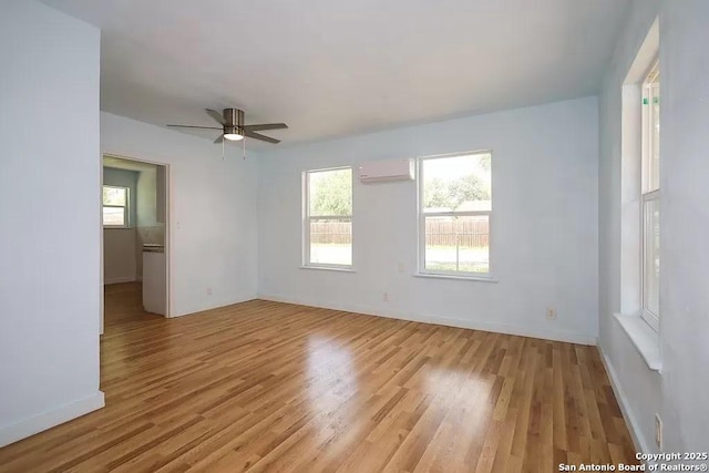 811 N Archer, Beeville, TX 78102 - unfurnished room with an AC wall unit, light wood-style floors, ceiling fan, and baseboards