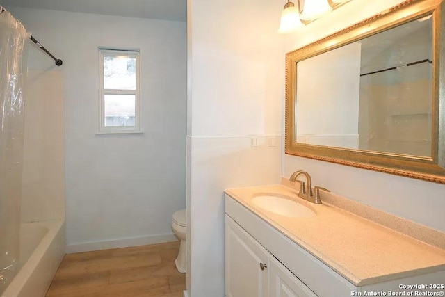 811 N Archer, Beeville, TX 78102 - full bath with wood finished floors, vanity, toilet, baseboards, and shower / tub combo with curtain