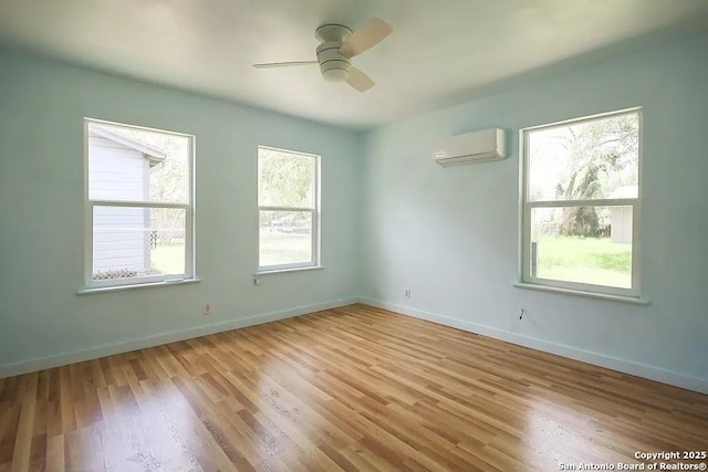 811 N Archer, Beeville, TX 78102 - spare room featuring a wall unit AC, light wood-style flooring, a ceiling fan, and baseboards