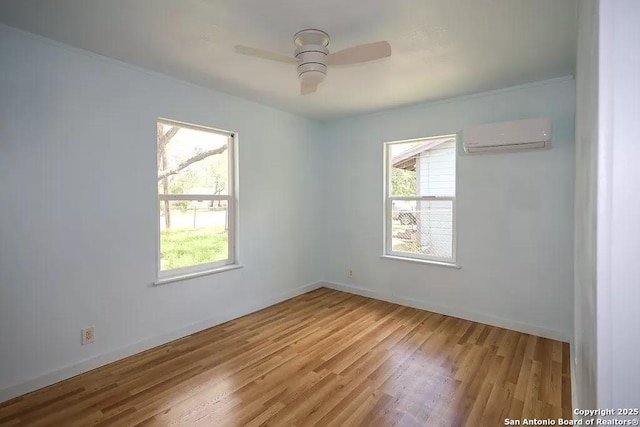 811 N Archer, Beeville, TX 78102 - empty room with a wall mounted AC, light wood-type flooring, ceiling fan, and baseboards