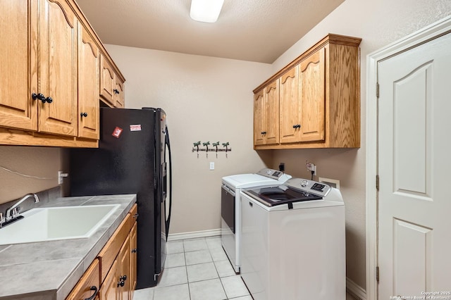 5718 Elam Way, San Antonio, TX 78261 - washroom with separate washer and dryer, cabinet space, light tile patterned flooring, and baseboards