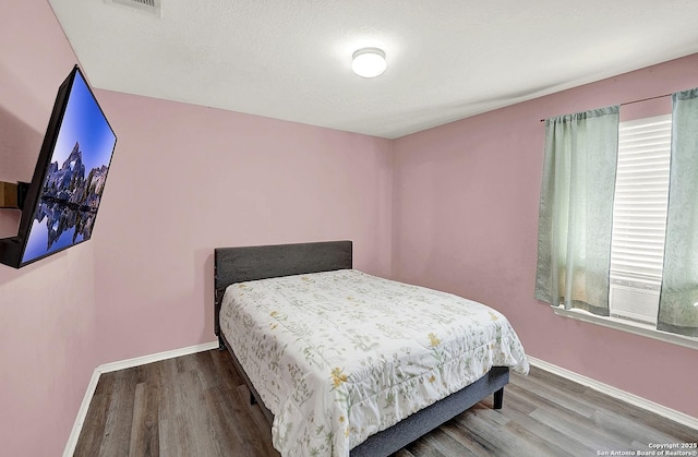8810 Pensive, Converse, TX 78109 - bedroom featuring wood finished floors and baseboards