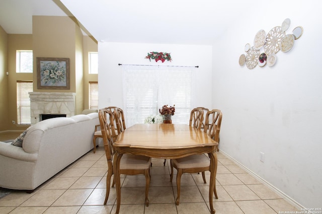8219 Wayside Crk, San Antonio, TX 78255 - dining room featuring light tile patterned flooring, a fireplace, and baseboards