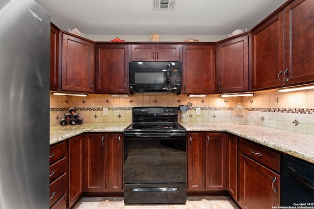 6431 Brookway, San Antonio, TX 78240 - kitchen featuring black appliances, light stone counters, tasteful backsplash, and light tile patterned floors