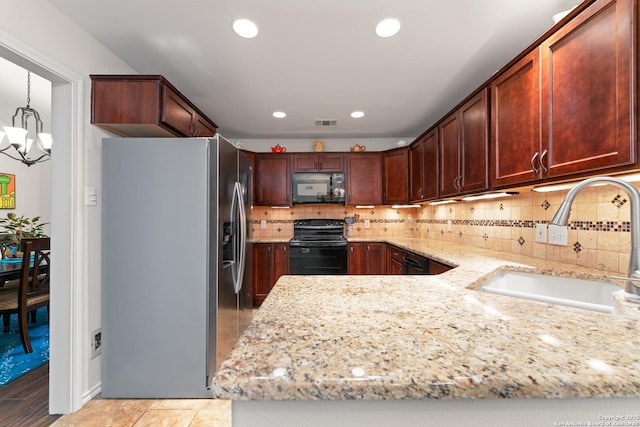 6431 Brookway, San Antonio, TX 78240 - kitchen featuring black appliances, a sink, a chandelier, light stone countertops, and backsplash