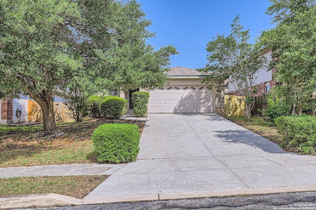 9215 Granberry, Universal City, TX 78148 - view of property hidden behind natural elements featuring a garage and concrete driveway
