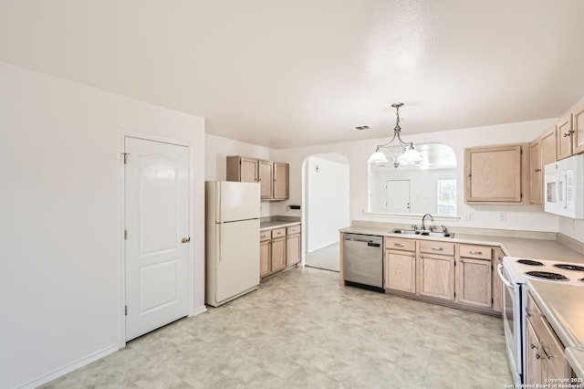 9215 Granberry, Universal City, TX 78148 - kitchen with white appliances, arched walkways, light brown cabinets, a sink, and light countertops