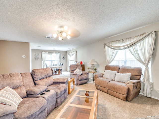 9427 Wildstone, San Antonio, TX 78254 - carpeted living room featuring a ceiling fan, a textured ceiling, and baseboards