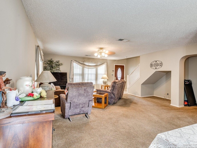 9427 Wildstone, San Antonio, TX 78254 - living room with light carpet, a textured ceiling, arched walkways, a ceiling fan, and stairway
