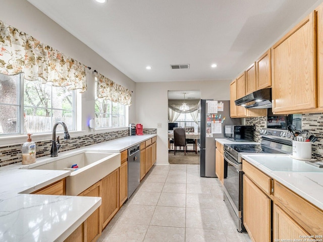 9427 Wildstone, San Antonio, TX 78254 - kitchen with stainless steel appliances, under cabinet range hood, backsplash, a sink, and recessed lighting